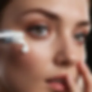 An elegant hand applying eye cream under the eye