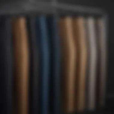 Variety of tailored pant styles displayed on a rack