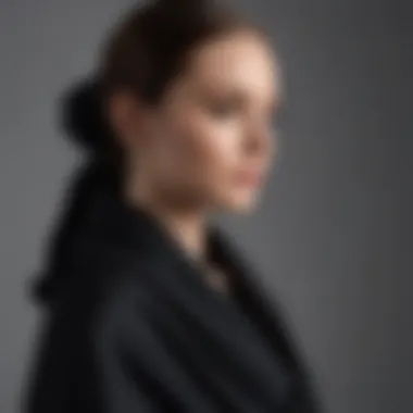 Stylish black cashmere wrap draped elegantly over a minimalist outfit